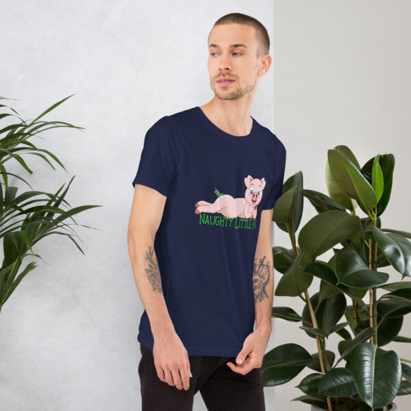 A man dressed in the "Naughty Little Pig" navy t-shirt, featuring a cartoon pig, stands near potted plants while gazing to the side.