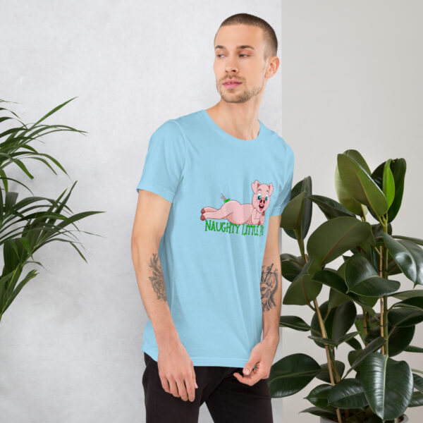 A man wearing a blue "Naughty Little Pig" t-shirt stands between two green plants, gazing to his right.