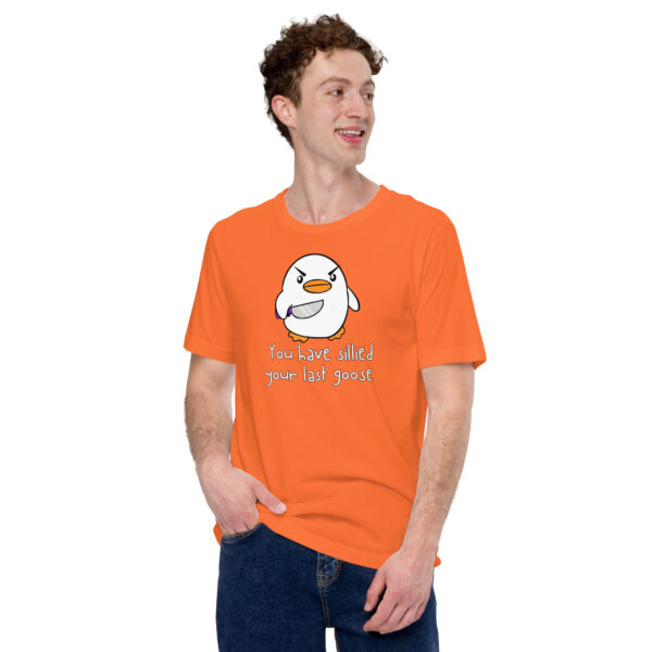 A person wearing an orange T-shirt showcasing the "You Have Sillied Your Last Goose" design with a cartoon bird poses stylishly, one hand resting in their pocket.