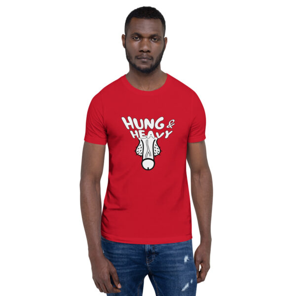 A person wearing a Hung and Heavy red t-shirt featuring a graphic of floppy dog ears is standing against a white background.