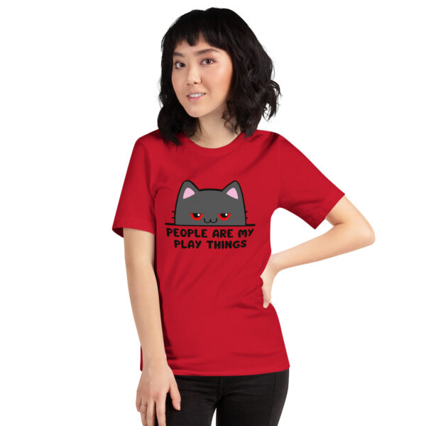 A person wearing a red T-shirt featuring a cartoon cat with the text "People Are My Play Things.