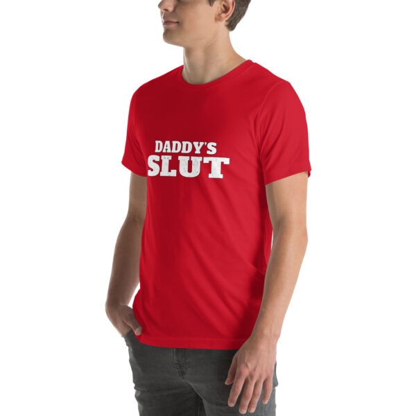 A person wearing a red T-shirt featuring white text saying the product name "Daddy's Slut," standing against a plain background.