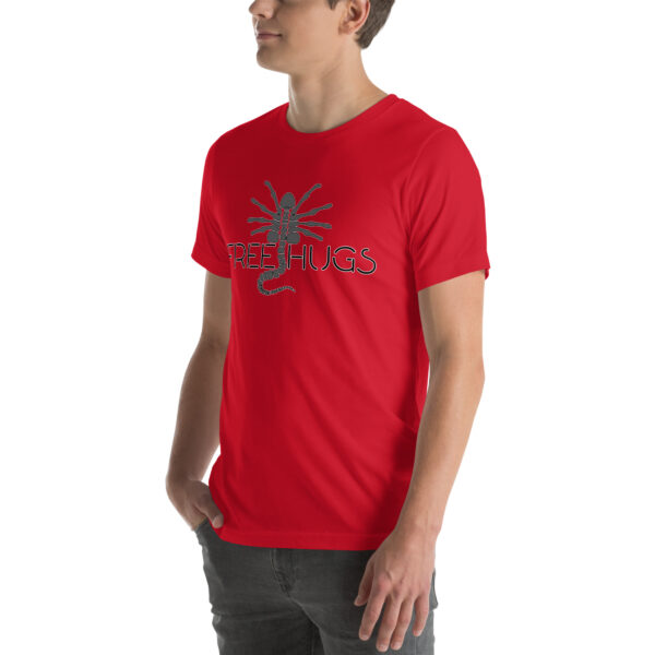 A person wearing the "Free Hugs" T-shirt, featuring a stylized spider and the text "FREE HUGS" in red, stands against a white background.