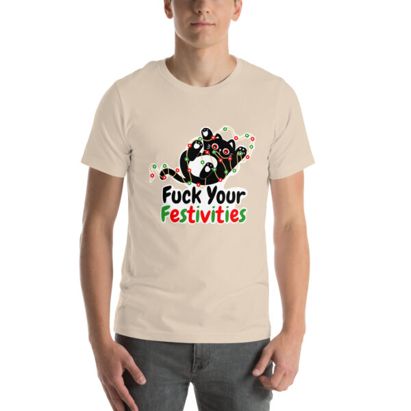 A person wearing a beige T-shirt featuring a colorful design and displaying the phrase from the "Fuck Your Festivities" collection.