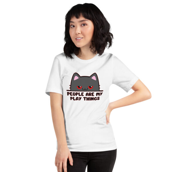 A person wearing a white T-shirt featuring the "People Are My Play Things" graphic design with a cat image.