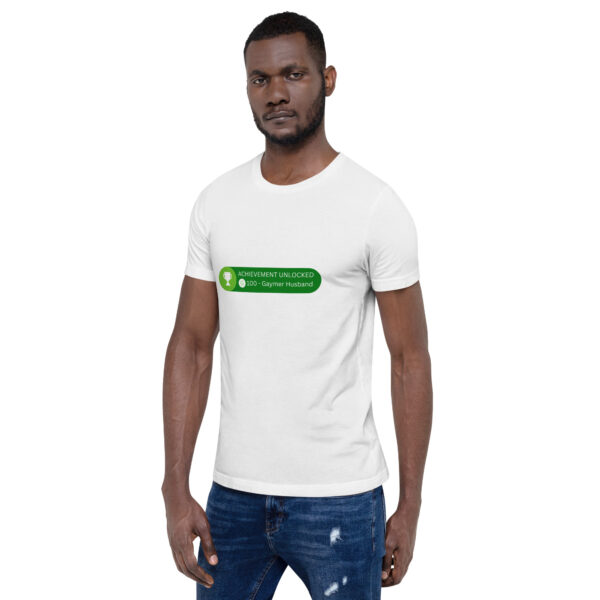 A person wearing a white T-shirt with green text stating "Achievement: Gaymer Husband - 100.