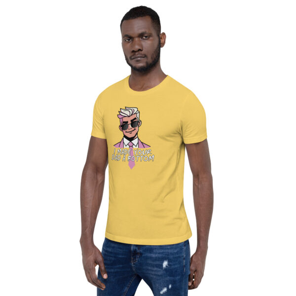 A man confidently wears the "I Made Your Dad A Bottom" yellow T-shirt featuring a cheeky cartoon graphic, perfectly paired with ripped jeans.