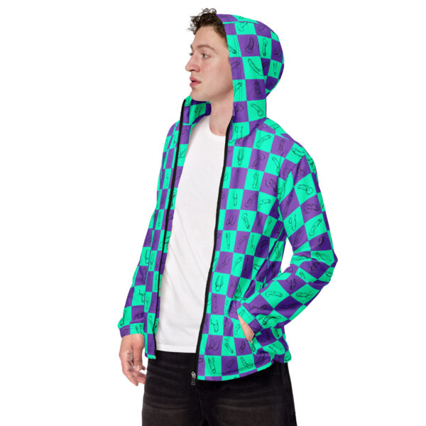 Person wearing the Zip Up, a hooded jacket featuring a blue and green checkered pattern with abstract designs, standing against a white background.