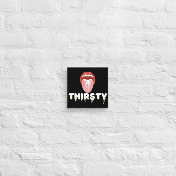 The sentence can be rewritten as: "A black square featuring a red open mouth with a dripping tongue, accompanied by the bold white letters spelling out 'THIRSTY', is showcased on the Thirsty Canvas.