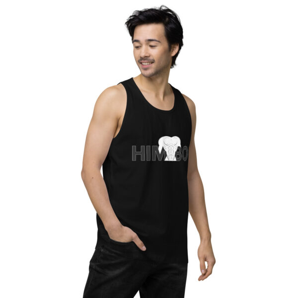 Man wearing the Himbo Tank, featuring an elephant and "HIMBO" print, looking to the side with his hand in his pocket.