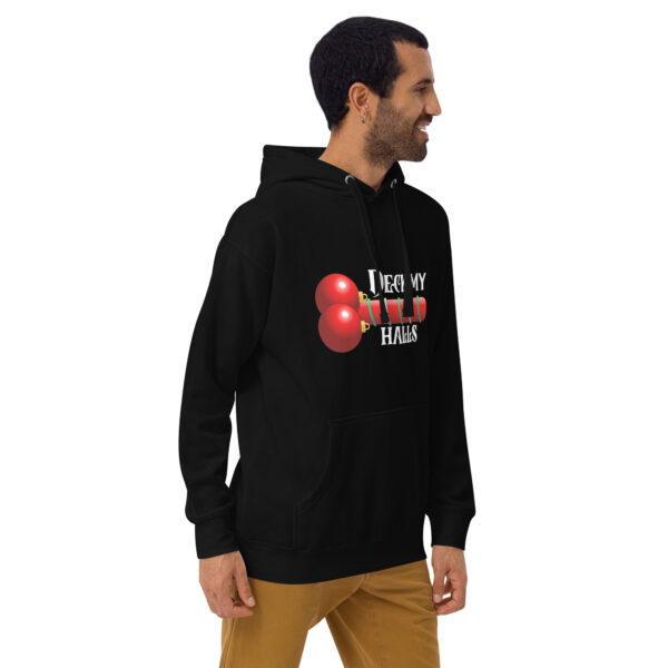 A man wearing the Deck My Halls Hoodie, featuring a black base with a red print design, stands smiling and looking to his right.