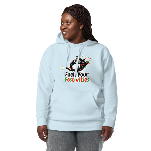 A person in a light "Fuck Your Festivities" hoodie with a festive cat design and text, standing against a white background.