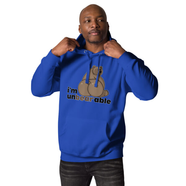 A man in a blue "i’m unbearable" hoodie, featuring a bear graphic, adjusts the hood.