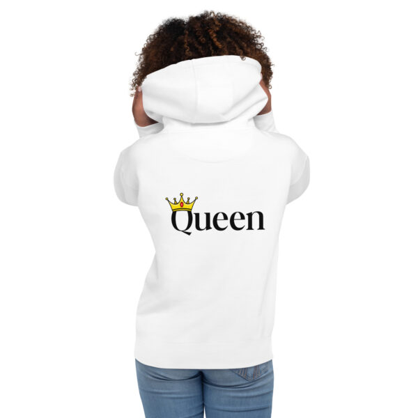 A person wearing the Queen Hoodie, which features a "Queen" and crown graphic on the back, is standing with their hands holding the hood.