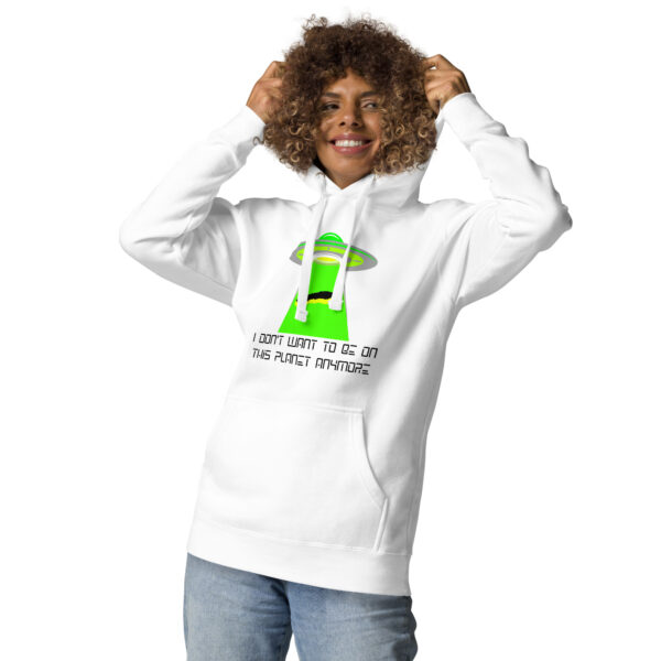 Person wearing the "I don't want to be on this planet anymore" hoodie, which features a green alien spaceship on a white background.