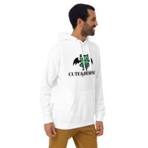 A man wearing the "Cute and Demonic Hoodie," featuring a green cartoon demon and text "CUTE & DEMONIC," stands against a plain background.