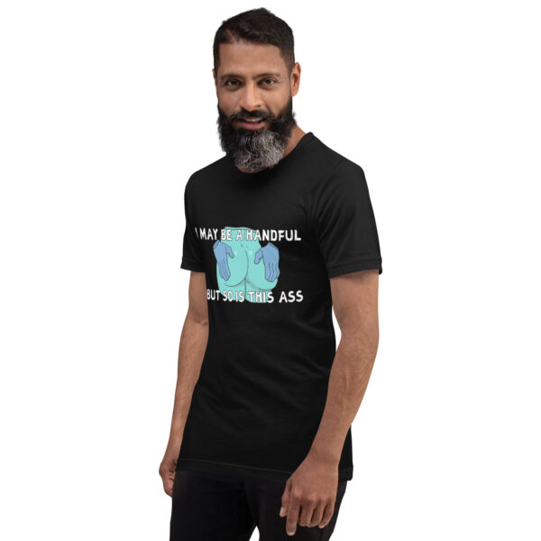 A person with a beard is wearing "A Handful," a black T-shirt featuring a humorous graphic and text, standing against a plain white background.