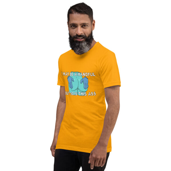 A man with a beard wears a yellow T-shirt featuring the cartoon design from "A Handful.