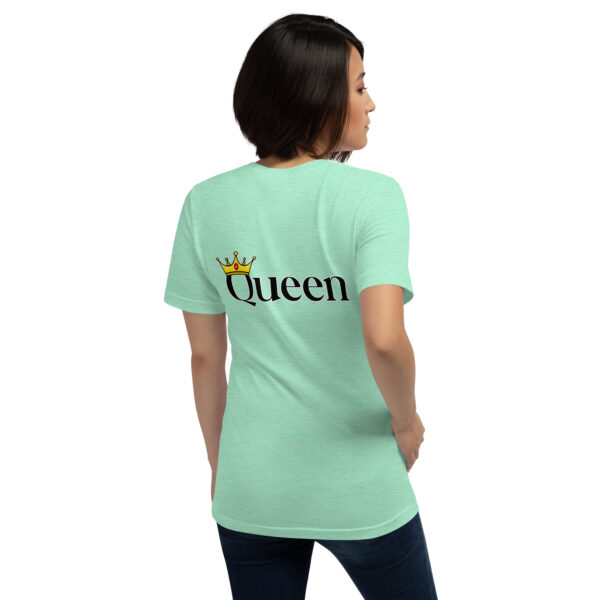 A person wearing a light green "Queen" T-shirt with a crown graphic on the back.