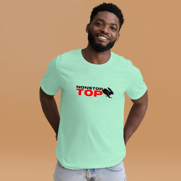 A person is smiling against a beige background, wearing a light green Nonstop Top t-shirt with "NONSTOP TOP" and a rabbit silhouette.