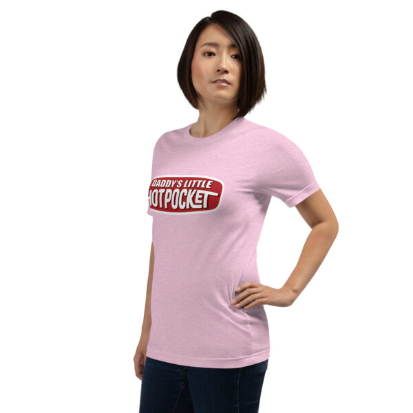 A person wearing a pink T-shirt emblazoned with the words "Daddy's Little Hotpocket" stands with one hand on their hip.