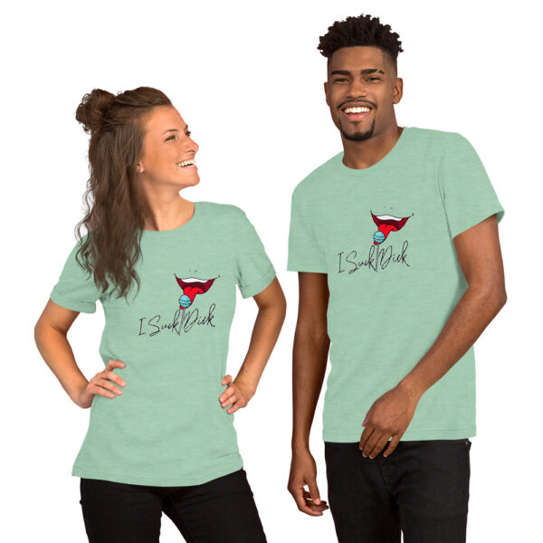 Two people stand side by side, smiling, and wearing matching light green t-shirts featuring a stylized red superhero logo and the "I Suck Dick" text design.