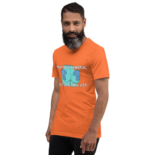 A person with a beard wearing the "A Handful" orange T-shirt featuring a humorous printed message stands against a white background.