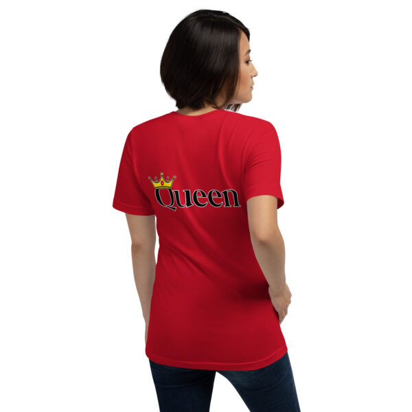 A person wearing a red "Queen" T-shirt featuring a crown graphic on the back.