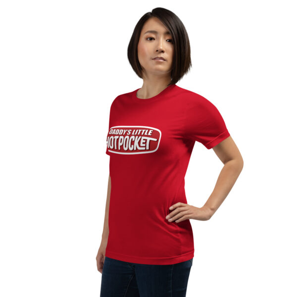 A person in a red T-shirt featuring the text "Daddy's Little Hotpocket," stands with one hand on their hip against a white backdrop.