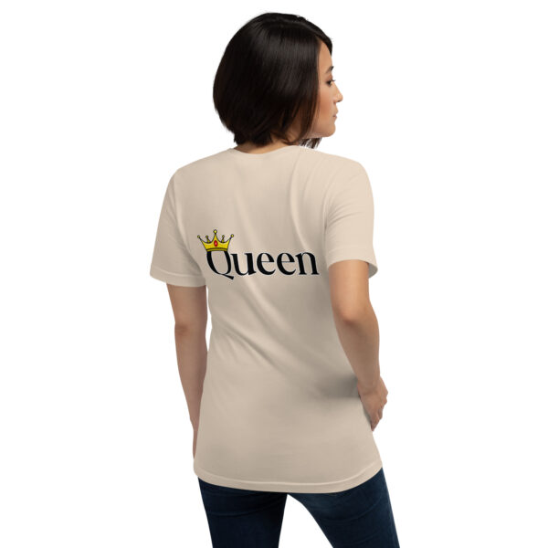 A woman is seen from behind wearing the "Queen" beige t-shirt, featuring a crown graphic and the word "Queen" on the back.