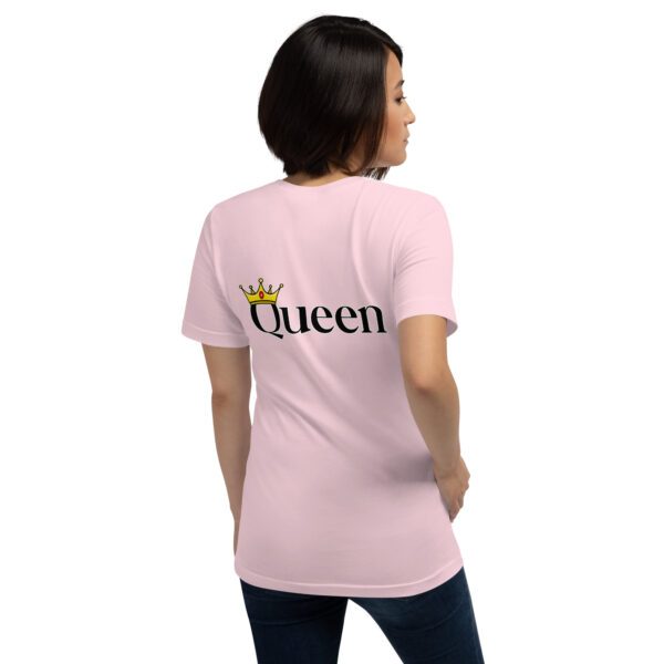 A woman wearing a pink T-shirt from the "Queen" collection, featuring a crown graphic and the word "Queen" on the back, is facing away.