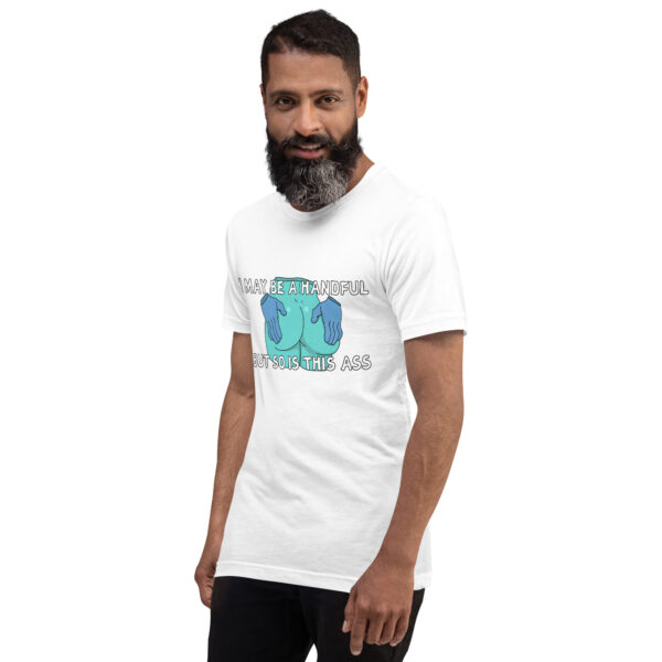 A bearded man wearing a white t-shirt featuring the "A Handful" graphic design stands against a plain background.